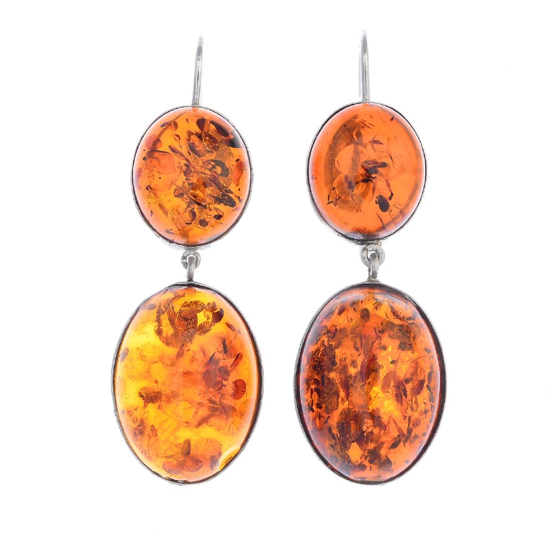 A pair of amber earrings. Each designed as an oval (1 of 2)