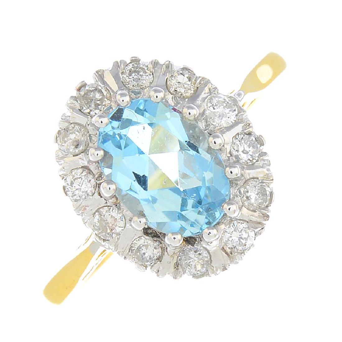 An 18ct gold diamond and aquamarine cluster ring. The (1 of 3)