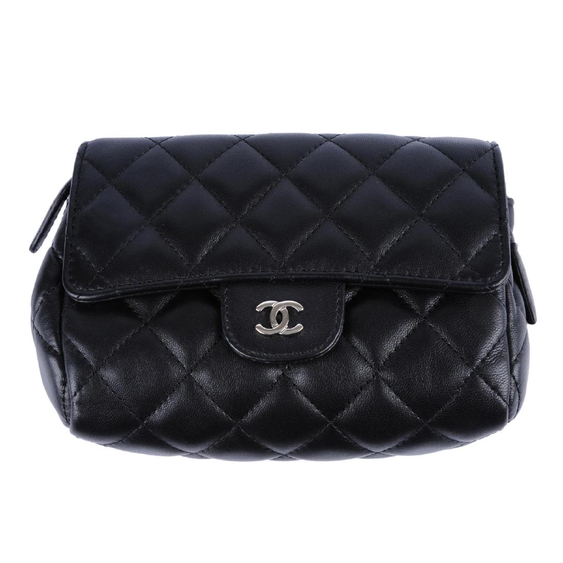 CHANEL - a black quilted make-up pouch. Designed with a (1 of 2)