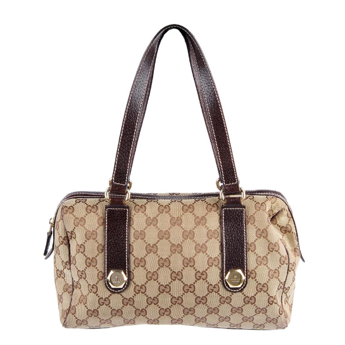 GUCCI - a Charmy Boston handbag. Crafted in brown and (1 of 3)
