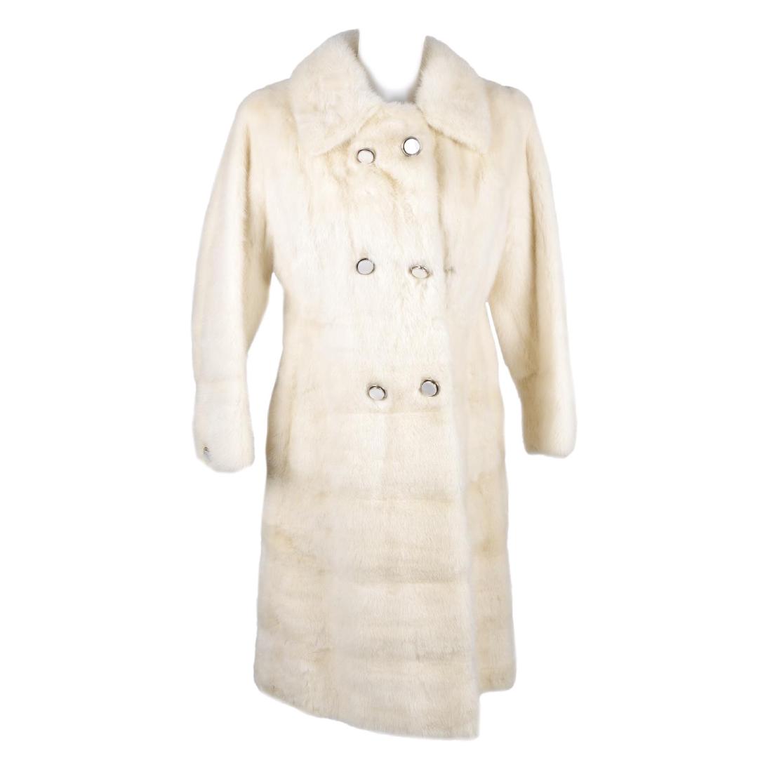 A knee-length pearl mink fitted coat. Featuring a (1 of 2)