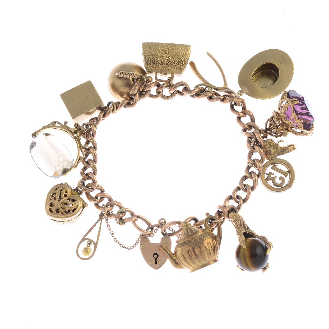 A mid 20th century 9ct gold charm bracelet. The: A mid 20th century 9ct gold charm bracelet. The curb-link chain, suspending thirteen 9ct gold charms, to include a heart-shape locket, a tiger's-eye sphere and claw, a moneybox, with ten further gold 