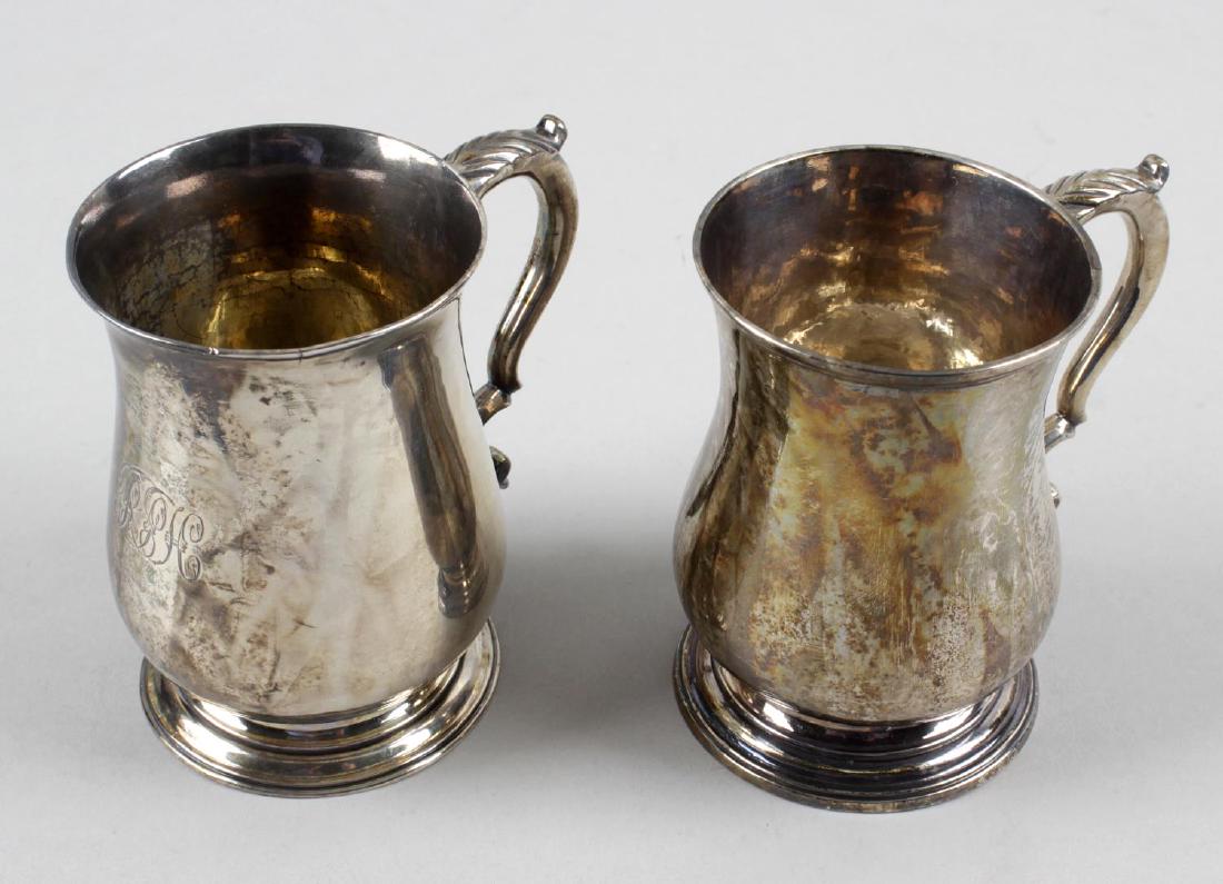 Two George III small silver mugs, each of baluster form: Two George III small silver mugs, each of baluster form to a footed base with a leaf capped double scroll handle, the first also monogram engraved and hallmarked London 1765, maker's mark R.S, possibl