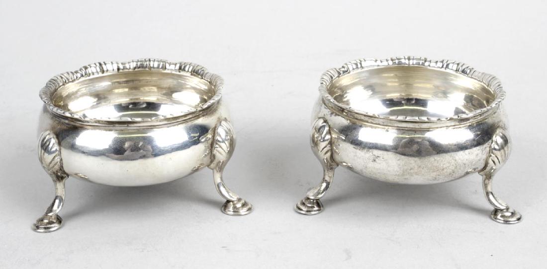Two George III silver open salts, each of cauldron form: Two George III silver open salts, each of cauldron form with fluted lobed rim, and raised upon three hoof feet, one hallmarked David Hennell I & Robert Hennell I, London 1763, the other with hallmarks