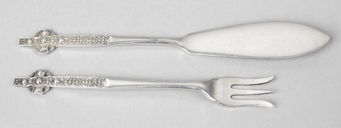 A Scottish provincial butter knife and fork, each with: A Scottish provincial butter knife and fork, each with a Celtic cross terminal, by R. Lindsay of Oban. Hallmarks also for Sheffield 1927 alongside a further maker's mark. Length of knife 5 1/8 inches