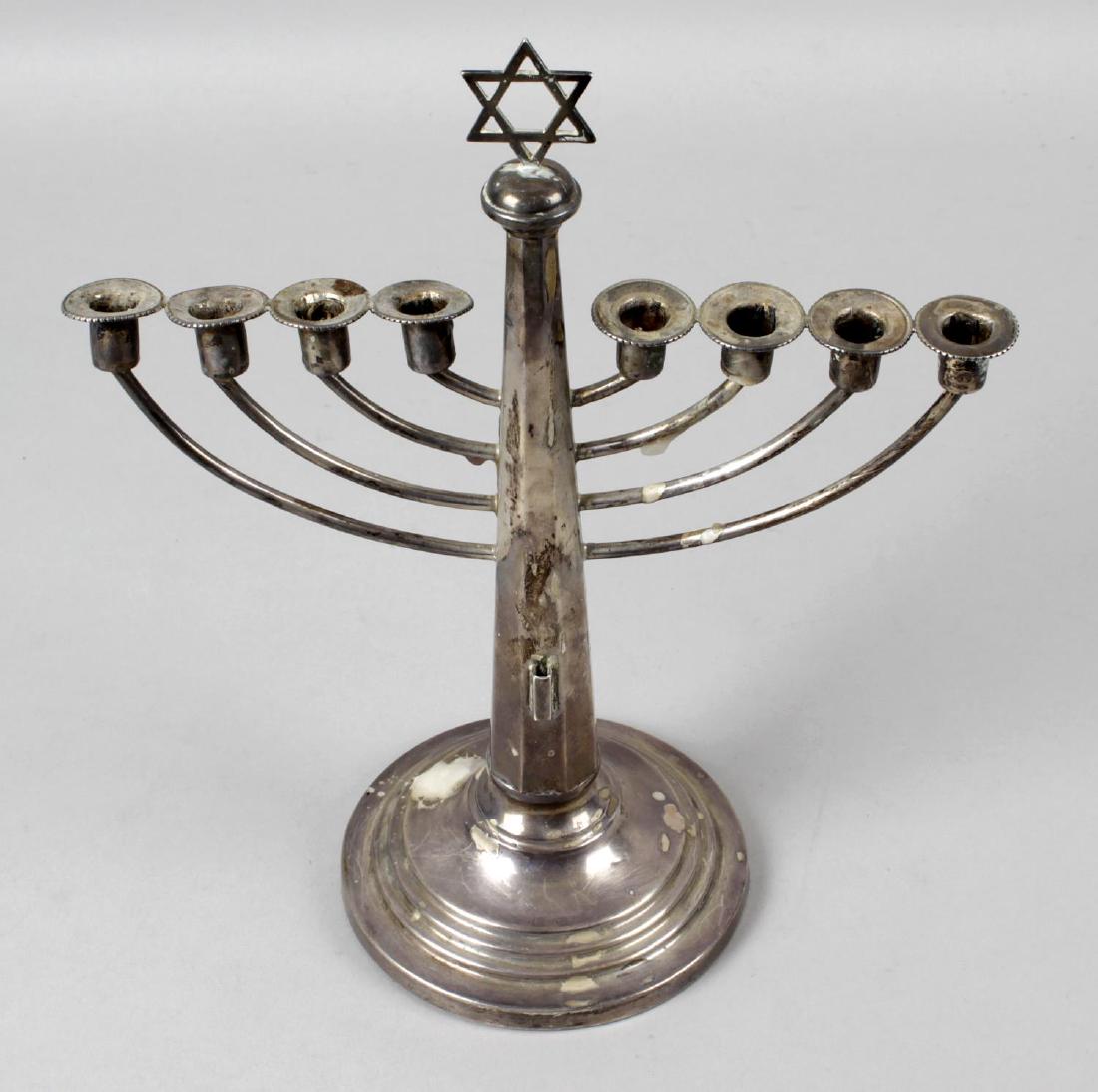 Judaica, a mid-twentieth century silver mounted eight: Judaica, a mid-twentieth century silver mounted eight light Menorah, the stepped and loaded circular base rising to a tapering central column surmounted with the Star of David. Hallmarked Bert Gordon,