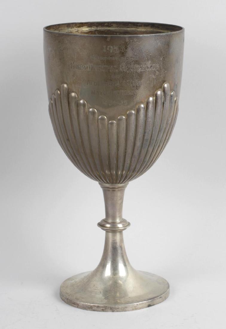 A late Victorian silver trophy cup, of goblet form with: A late Victorian silver trophy cup, of goblet form with fluted base, upon knopped tapering stem and spreading circular foot, the bowl with personal engraving, Hallmarked Robert James Chaplin & Sons, L