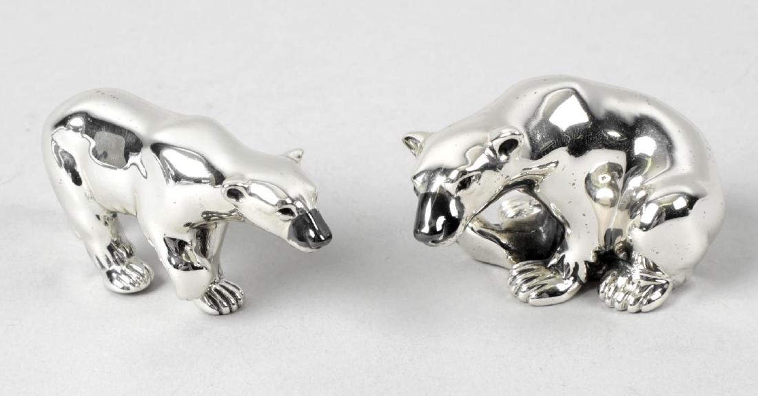 Two modern silver ornaments of polar bears, one: Two modern silver ornaments of polar bears, one modelled standing and the other seated, with black painted detail to faces. Hallmarked London 2008, also marked 925. Lengths measuring 2 1/2 inches (6.5