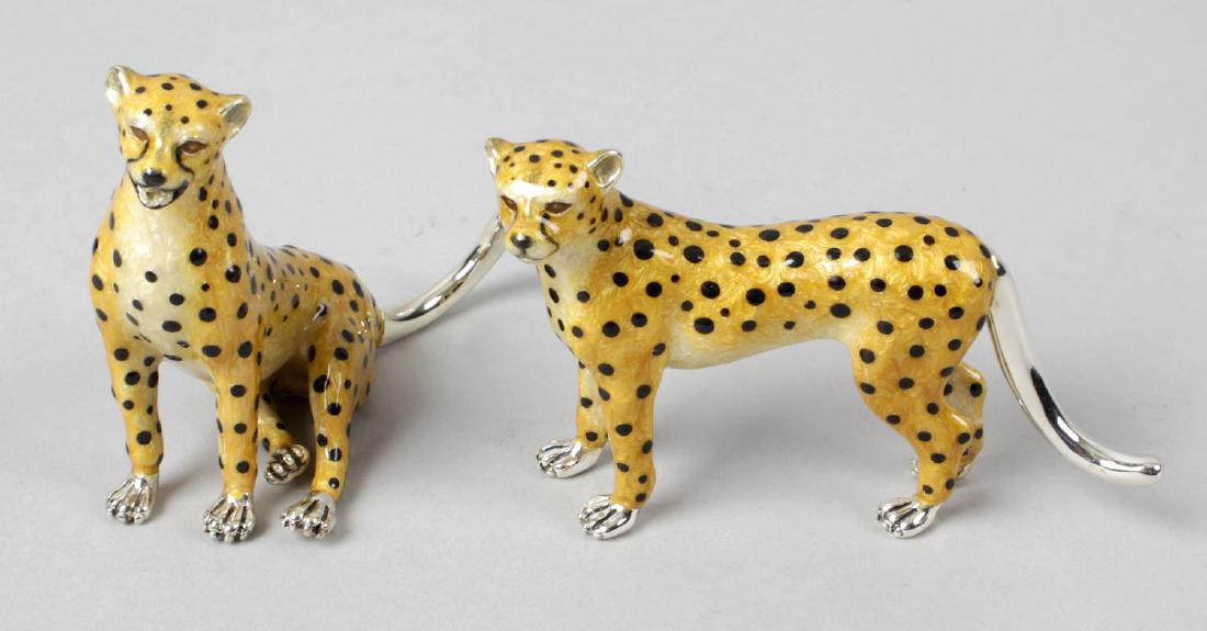 Two modern silver and enamel ornaments of leopards, one: Two modern silver and enamel ornaments of leopards, one modelled seated and the other standing, each with light brown fully enamelled body and black spot detail. Hallmarked London 2013 and 2014, also