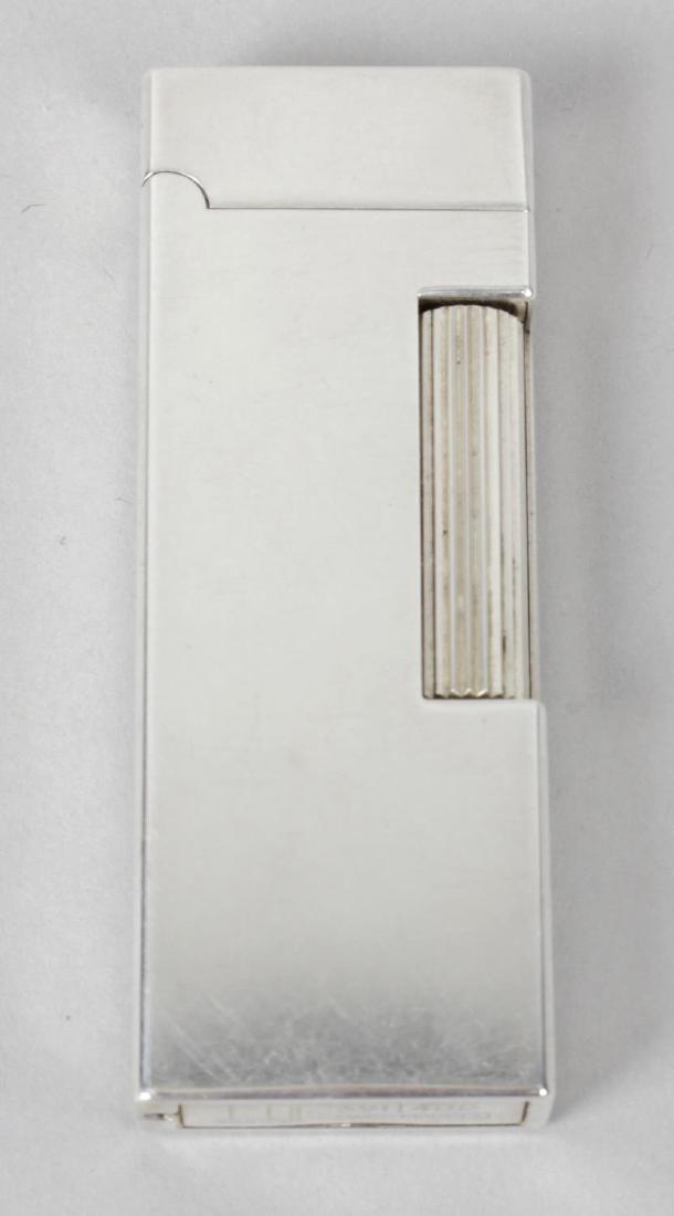 A silver Dunhill cigarette lighter, of plain: A silver Dunhill cigarette lighter, of plain rectangular form, marked 391/400 and hallmarked Alfred Dunhill & Sons, London 1993, 2.5 (6.5cm) high, in maker's fitted box.