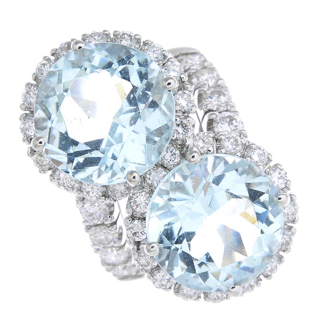 An 18ct gold aquamarine and diamond ring. Designed as (1 of 3)