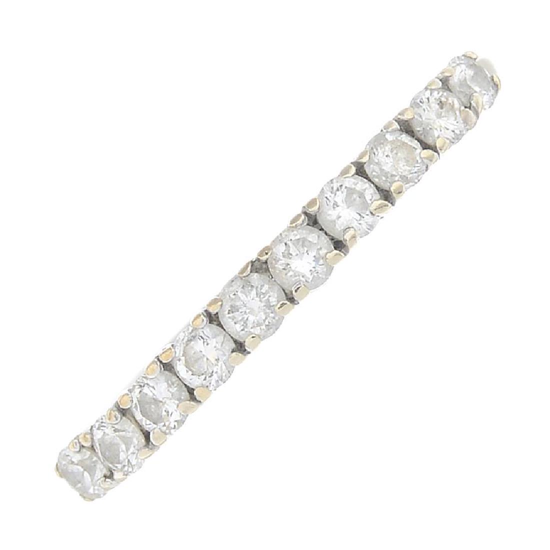 An 18ct gold diamond half eternity ring. Designed as a: An 18ct gold diamond half eternity ring. Designed as a brilliant-cut diamond line. Total diamond weight 0.25ct, stamped to band. Hallmarks for Sheffield. Ring size I1/2. Weight 1.1gms.