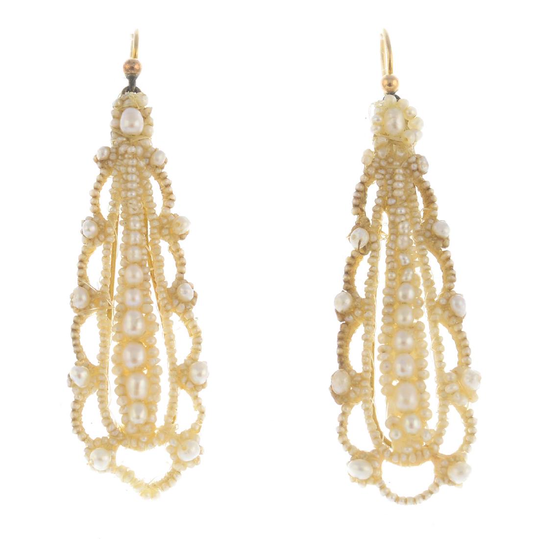 A pair of Georgian seed pearl earrings. Each designed: A pair of Georgian seed pearl earrings. Each designed as graduated seed pearl line, within a seed pearl scalloped surround. Length 5.5cms. Weight 4.4gms.