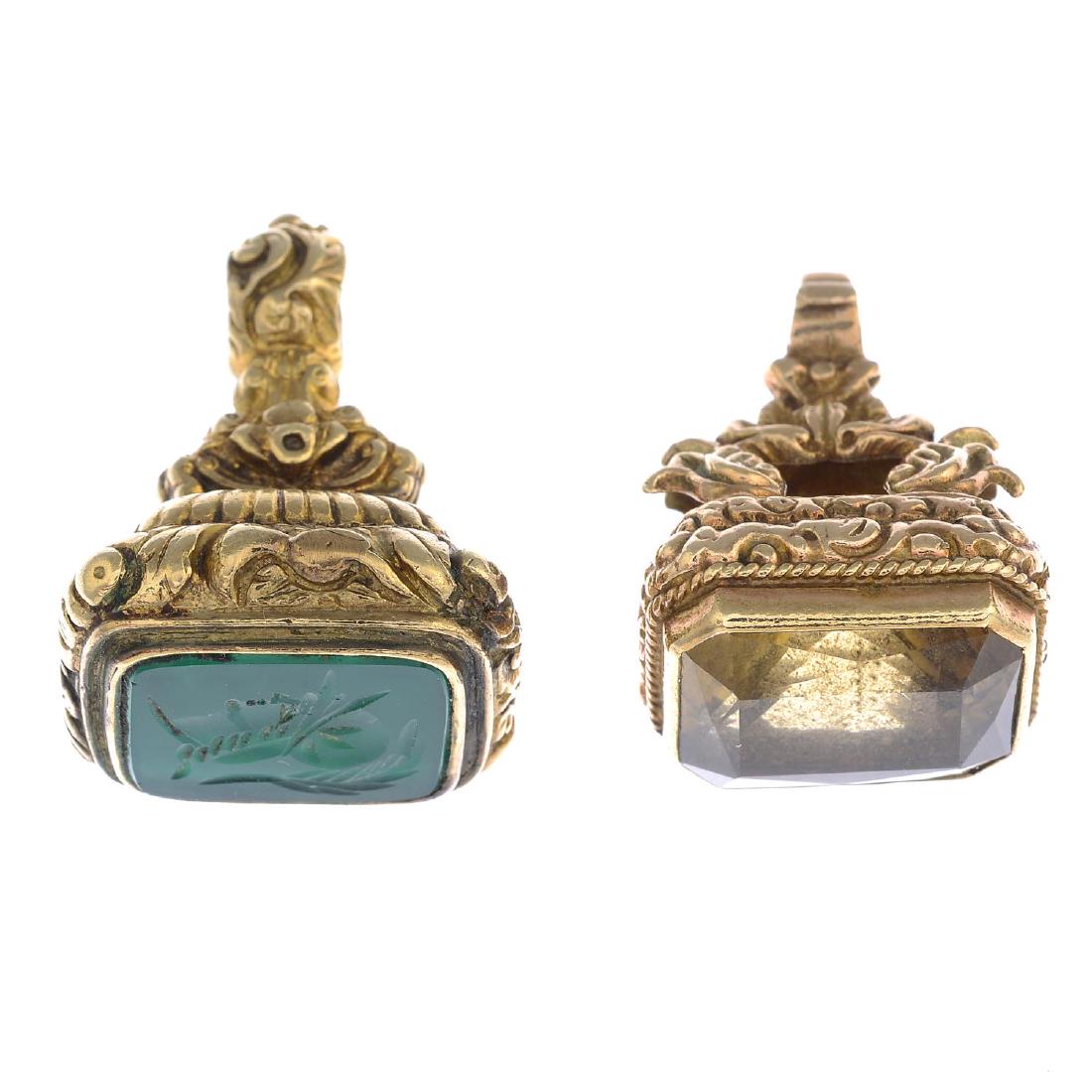 Two mid 20th century 9ct gold gem-set fobs. To include: Two mid 20th century 9ct gold gem-set fobs. To include a green chalcedony intaglio fob, together with a rectangular-shape citrine fob, each with scrolling engraved pedestals. Hallmarks for London, 196