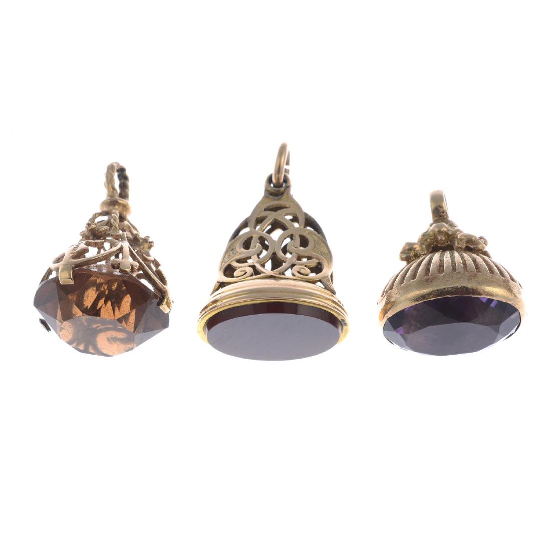 Three 9ct gold gem-set fobs. To include an Edwardian: Three 9ct gold gem-set fobs. To include an Edwardian carnelian fob, an oval-shape amethyst fob, together with a circular-shape paste fob. Hallmarks for Birmingham, 1906, 1963 and London, 1966. Lengths