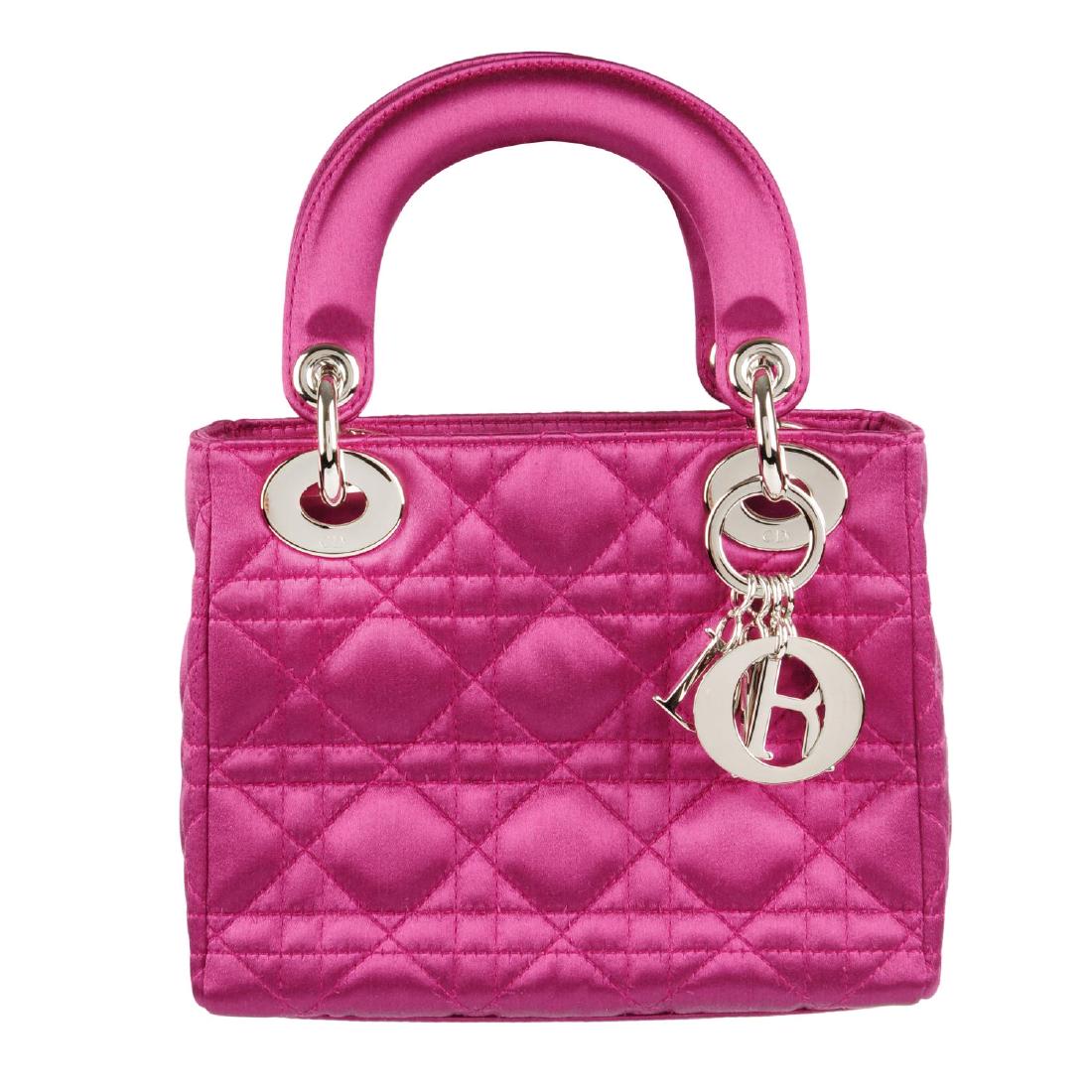 CHRISTIAN DIOR - a magenta satin Mini Cannage Lady Dior: CHRISTIAN DIOR - a magenta satin Mini Cannage Lady Dior handbag. Designed with a quilted pink satin exterior, featuring rigid looping top handles, polished silver-tone hardware, maker's signature hang