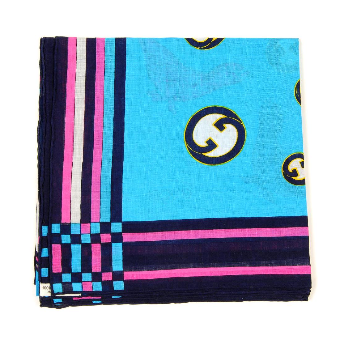 GUCCI - a cotton scarf. Designed with a pink and blue: GUCCI - a cotton scarf. Designed with a pink and blue seal motif on an aqua blue background with a large circular pattern and dark blue border. Measuring 88 by 88cms.