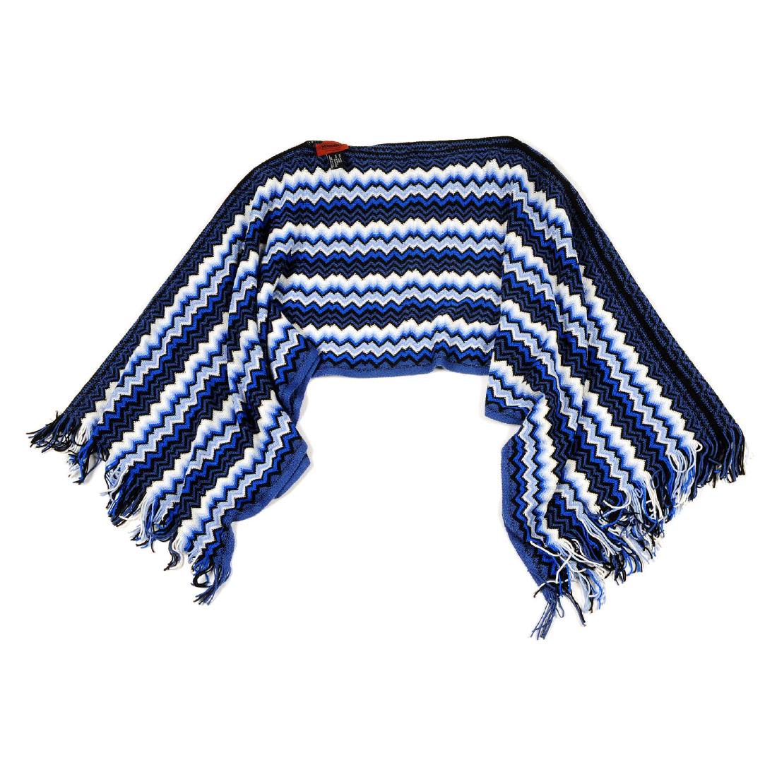 MISSONI - a poncho. Featuring maker's blue and white: MISSONI - a poncho. Featuring maker's blue and white classic zig-zag woven pattern and two fringed edges. Labelled Missoni. One size.
