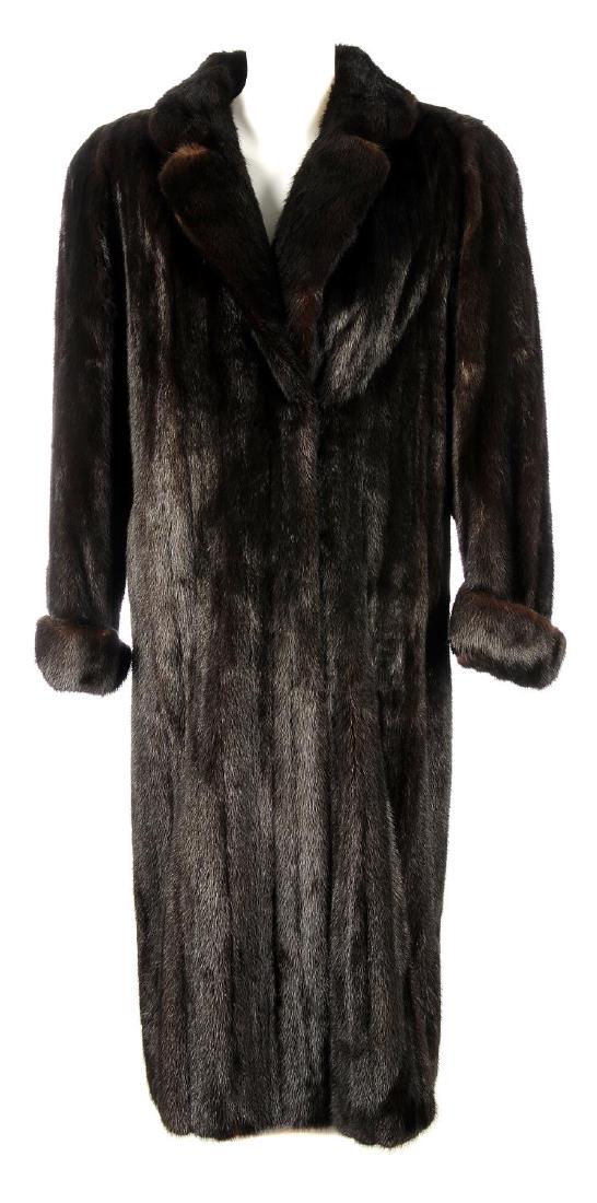 A full-length ranch mink coat. Designed with a notched: A full-length ranch mink coat. Designed with a notched lapel collar, turned up cuffs, hook and eye clip fastenings, two outer pockets and an inner ribbon tie. Chest measures approximately 42inches.