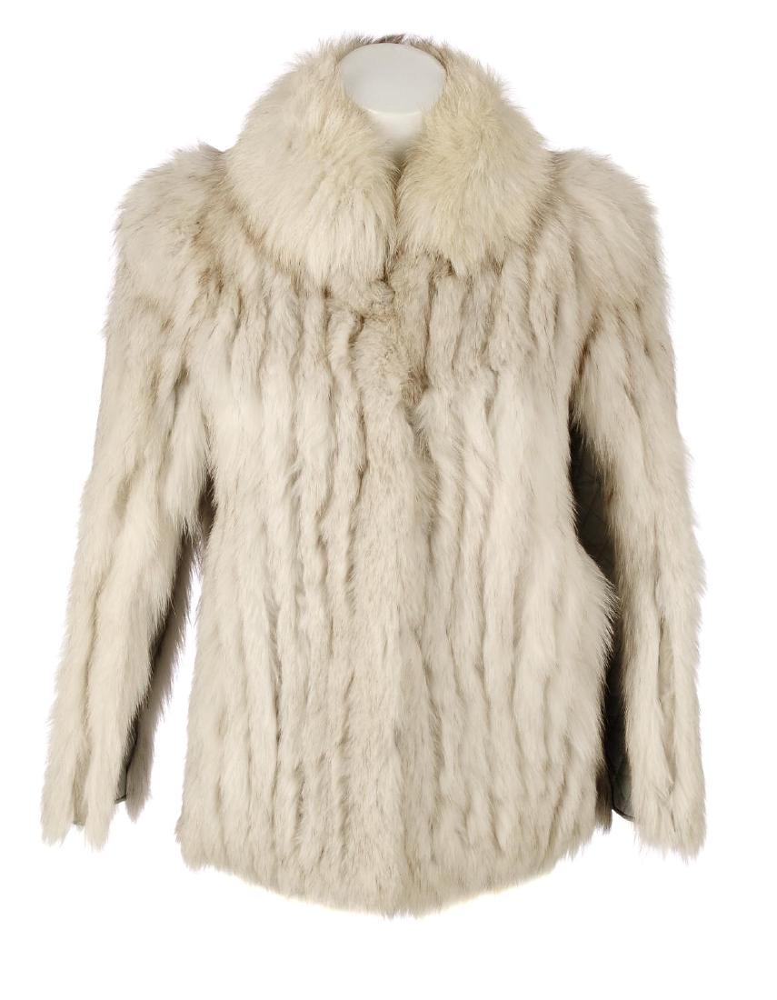SAGA - a blue fox fur coat. Designed with a short: SAGA - a blue fox fur coat. Designed with a short collar, hook and eye clip fastenings, quilted leather trim and two outer pockets. Labelled Saga Fox, size 8. Chest measures approximately 34inches.