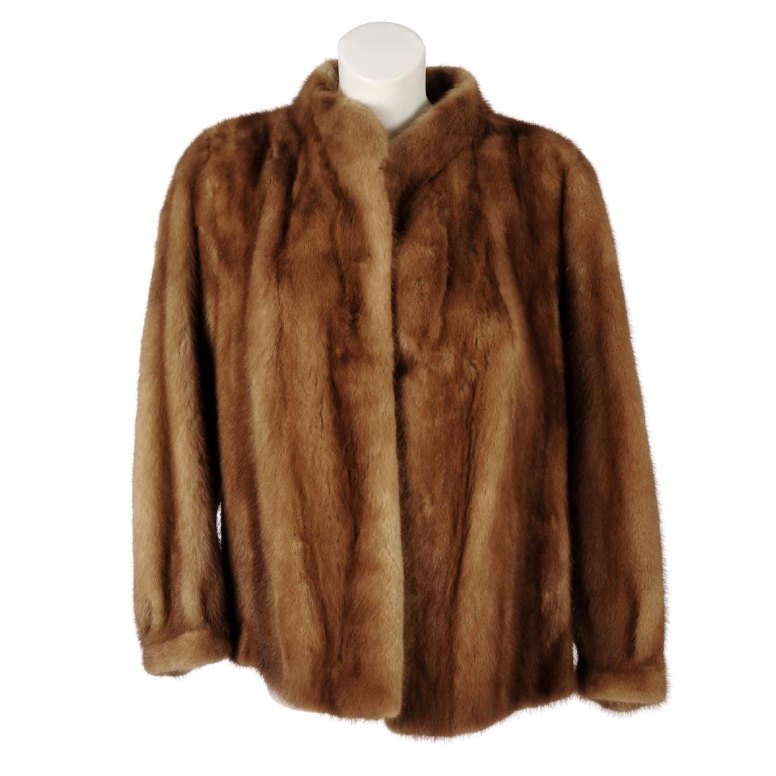 A pastel mink coat. Designed with a short Mandarin: A pastel mink coat. Designed with a short Mandarin collar, hook and eye front clip fastening and fitted cuffs. Chest measures approximately 42inches.