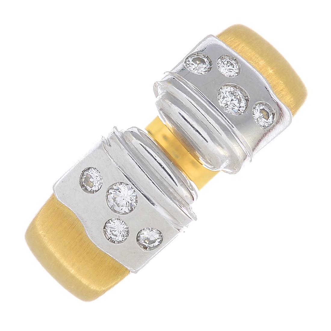 A diamond dress ring. The bi-colour, open band, with (1 of 3)