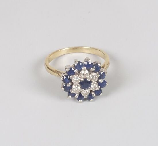 A circular claw set diamond and sapphir