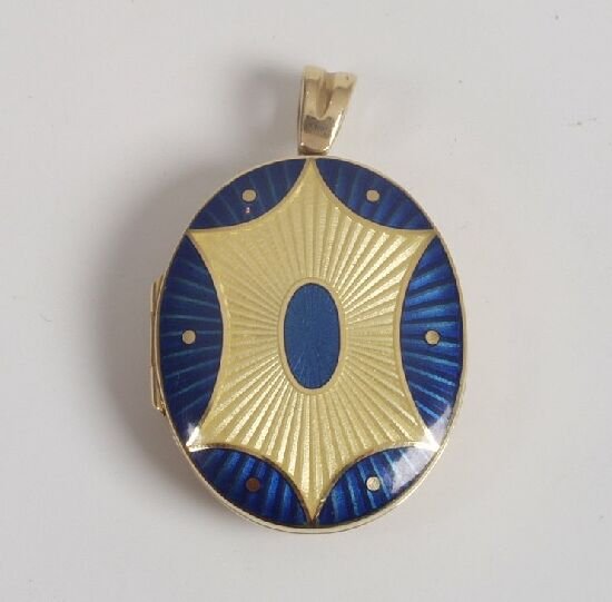 An 18ct gold oval locket with yellow an