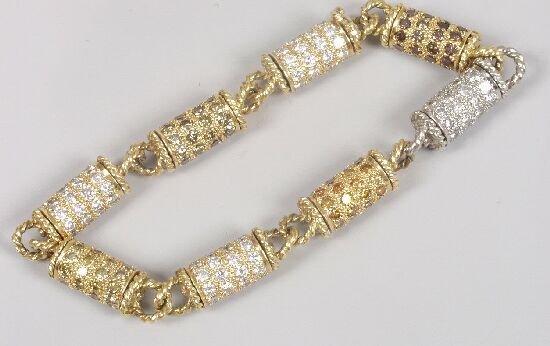 JULIUS COHEN - 18ct two coloured gold,: JULIUS COHEN - 18ct two coloured gold, diamond bracelet, composed of eight revolving cylindrical links set with brown, green, orange and colourless brilliant cut diamonds, with ropetwist curb links be
