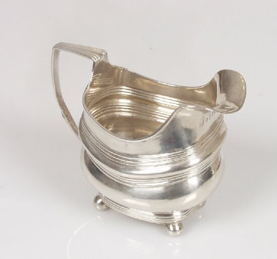 A late George III cream jug of rectangu