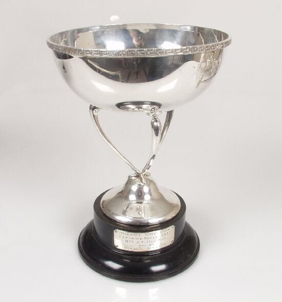 A silver trophy cup, the bowl with appl