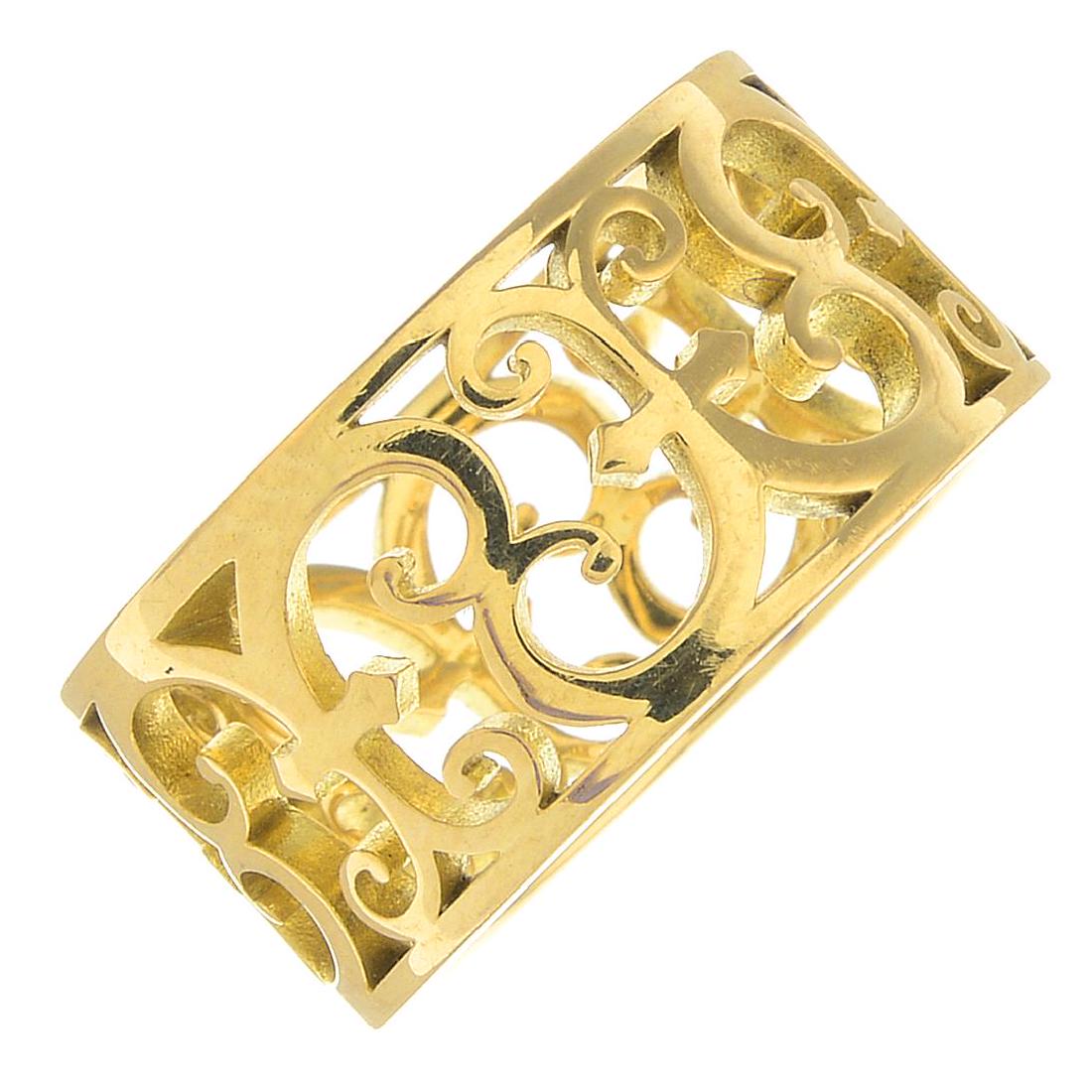 An openwork 'Enchant' band ring, by Tiffany & Co.Signed: An openwork 'Enchant' band ring, by Tiffany & Co.Signed T&Co.Stamped 750.Ring size L. 6.3gms.
