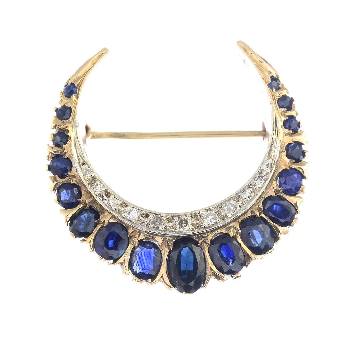 A 9ct gold sapphire and diamond crescent brooch. (1 of 2)
