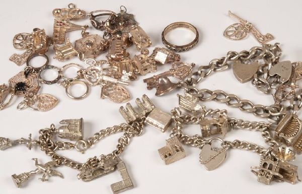 Three silver curb link bracelets with charms attac: Three silver curb link bracelets with charms attached, also a quantity of loose charms.