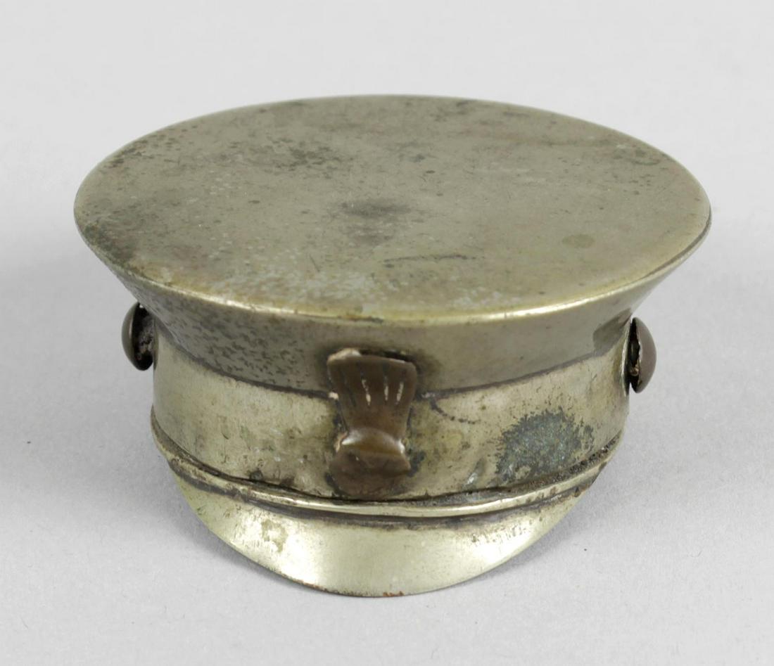 A novelty base metal snuff box and cover modelled as an: A novelty base metal snuff box and cover modelled as an Army Officers peaked cap, approx 2 (5cm) diameter.