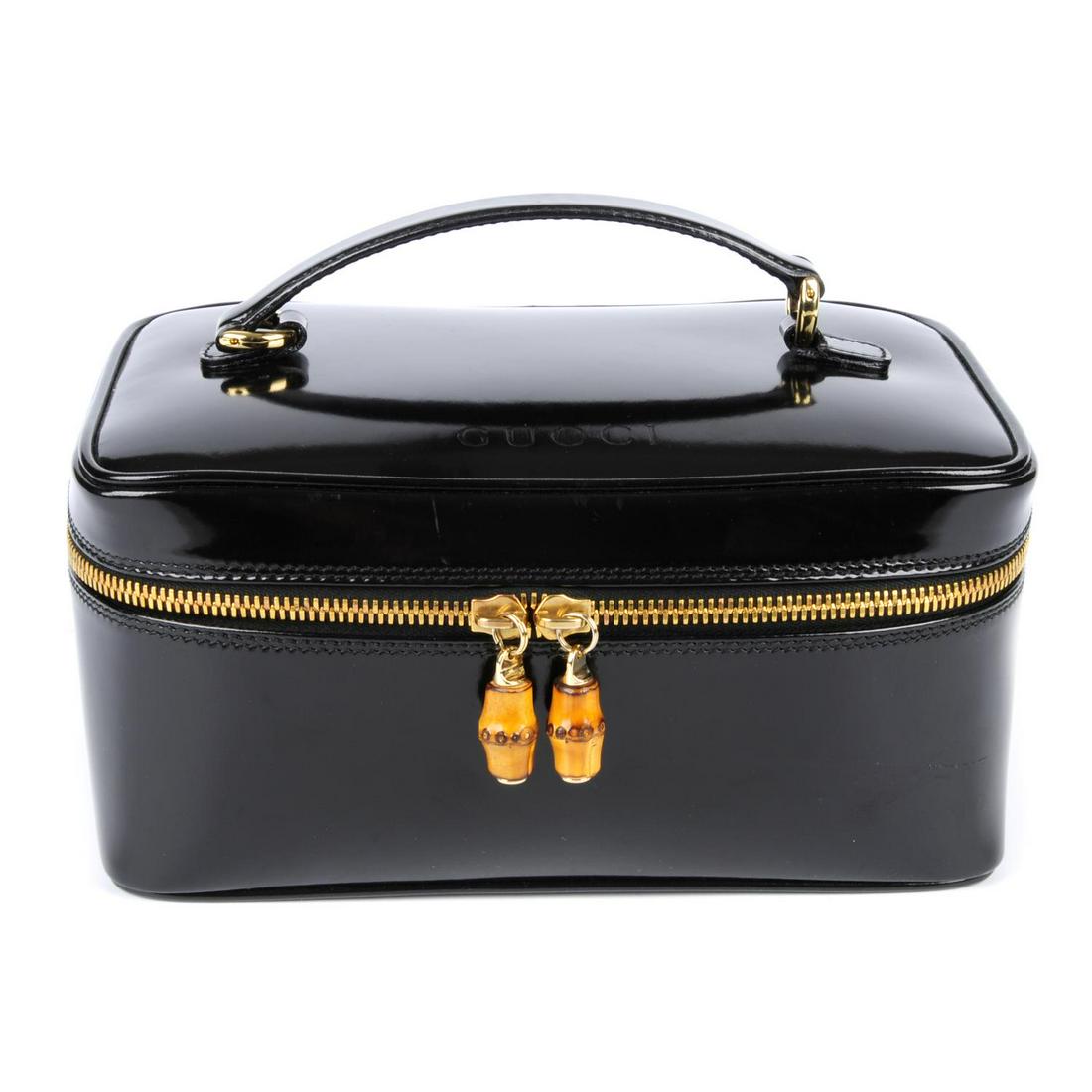 GUCCI - a black polished leather cosmetics case. (1 of 4)