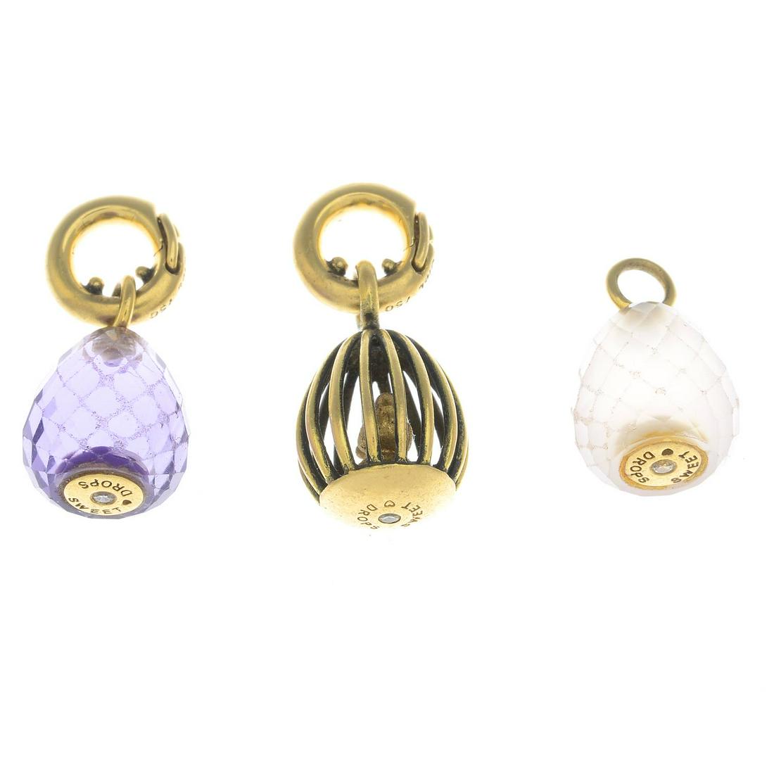 Three birdcage, amethyst and rose quartz 'Sweet Drops': Three birdcage, amethyst and rose quartz 'Sweet Drops' egg charms, with cord, by Charlotte lynggaard for Ole Lynggaard.Charms stamped 750.Length of charms 2.2 to 2.4cms. Weight of charms 11.8gms.