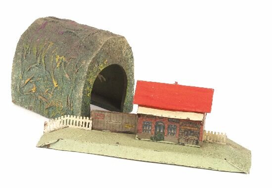 A wooden and cardboard Hornby 'O' gauge: A wooden and cardboard Hornby 'O' gauge straight tunnel section, together with a Bing 'O' gauge tinplate railway station, (a.f). (2).