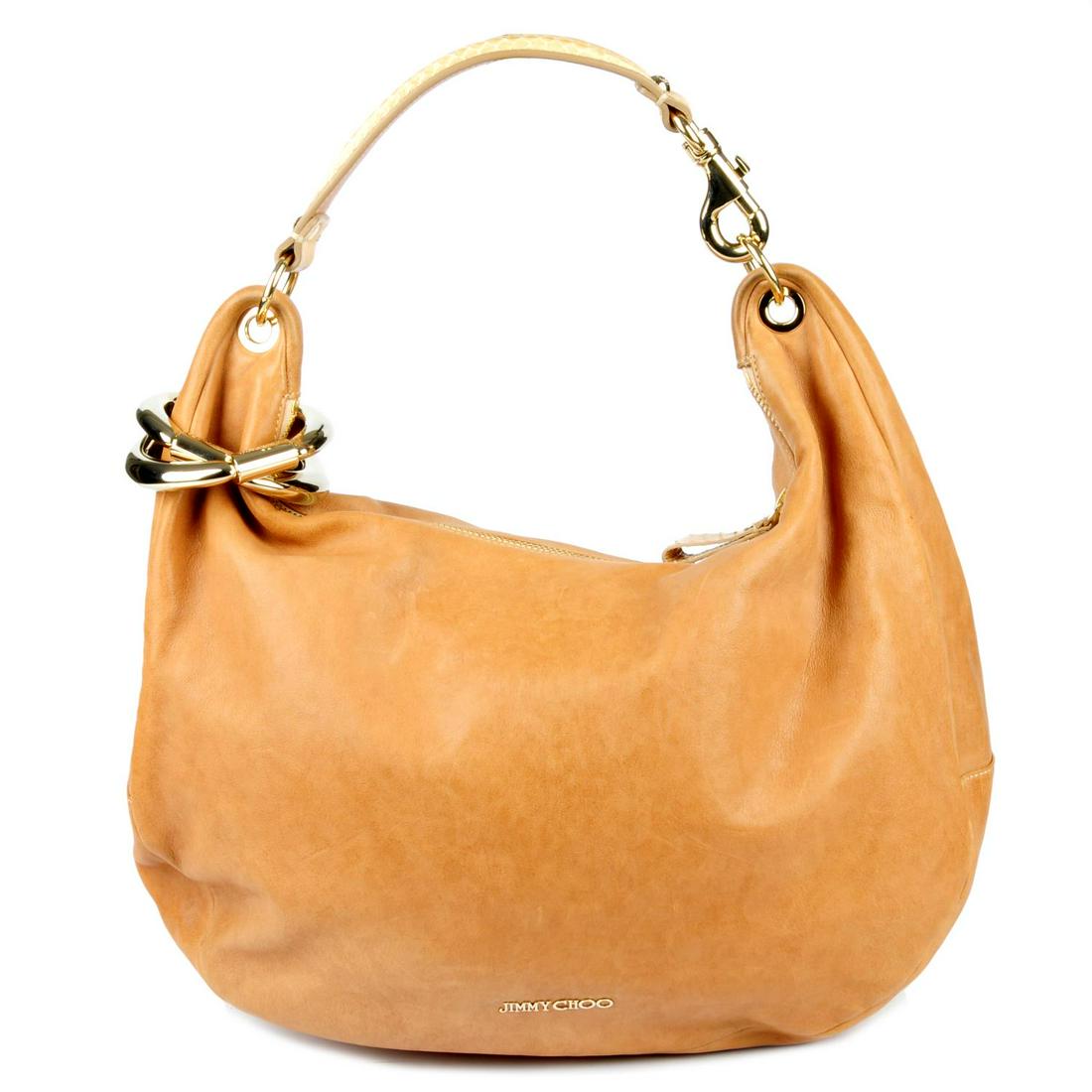 JIMMY CHOO - a Solar hobo handbag. Designed with a: JIMMY CHOO - a Solar hobo handbag. Designed with a slouchy crescent shape, featuring a beige leather exterior, pale gold-tone hardware, raised logo lettering to the lower front, structured snakeskin t
