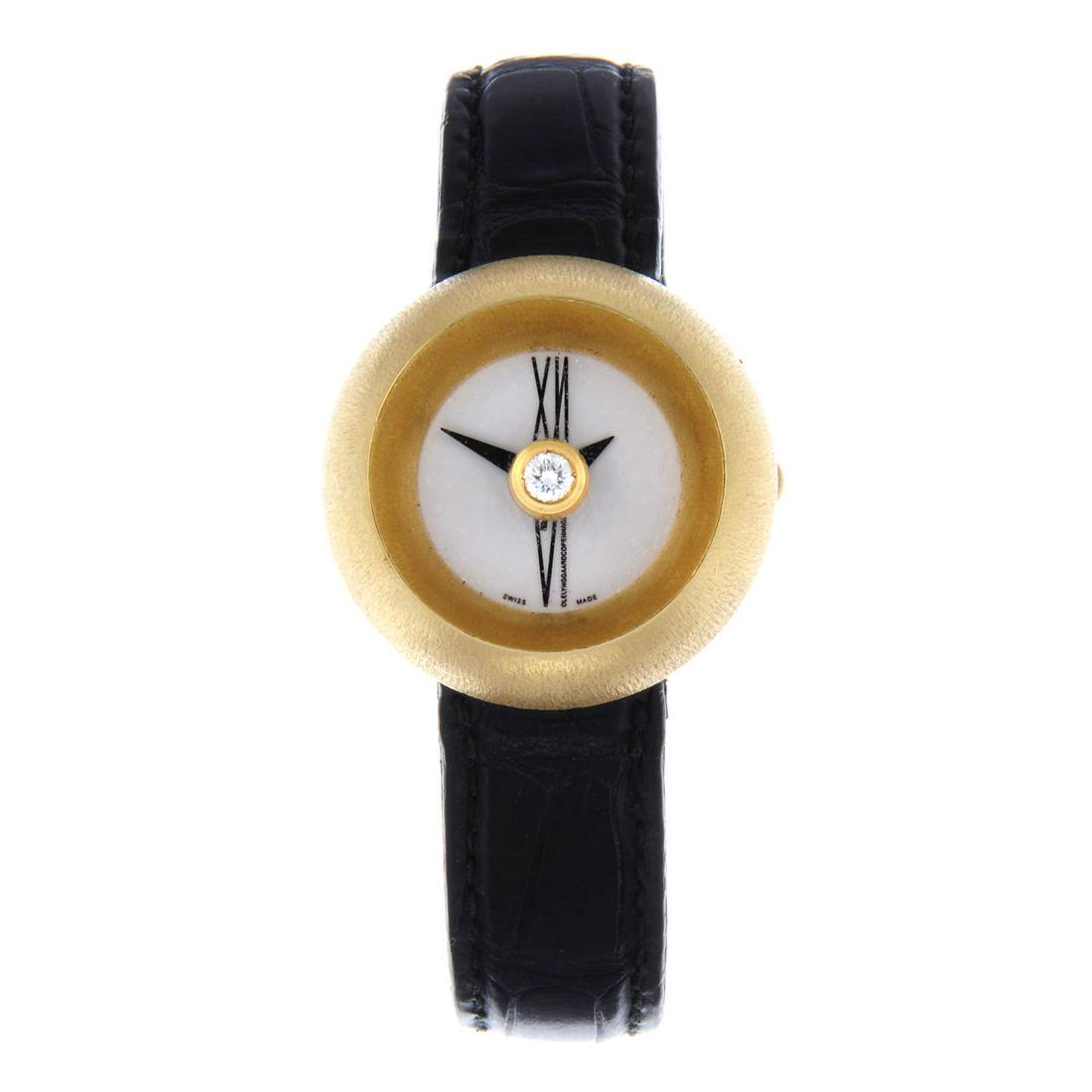 OLE LYNGGAARD - a lady's wrist watch with factory: OLE LYNGGAARD - a lady's wrist watch with factory diamond set centre feature. 18ct yellow gold case. Unsigned quartz movement. White dial. Fitted to a signed black alligator strap with bi-metal deploy