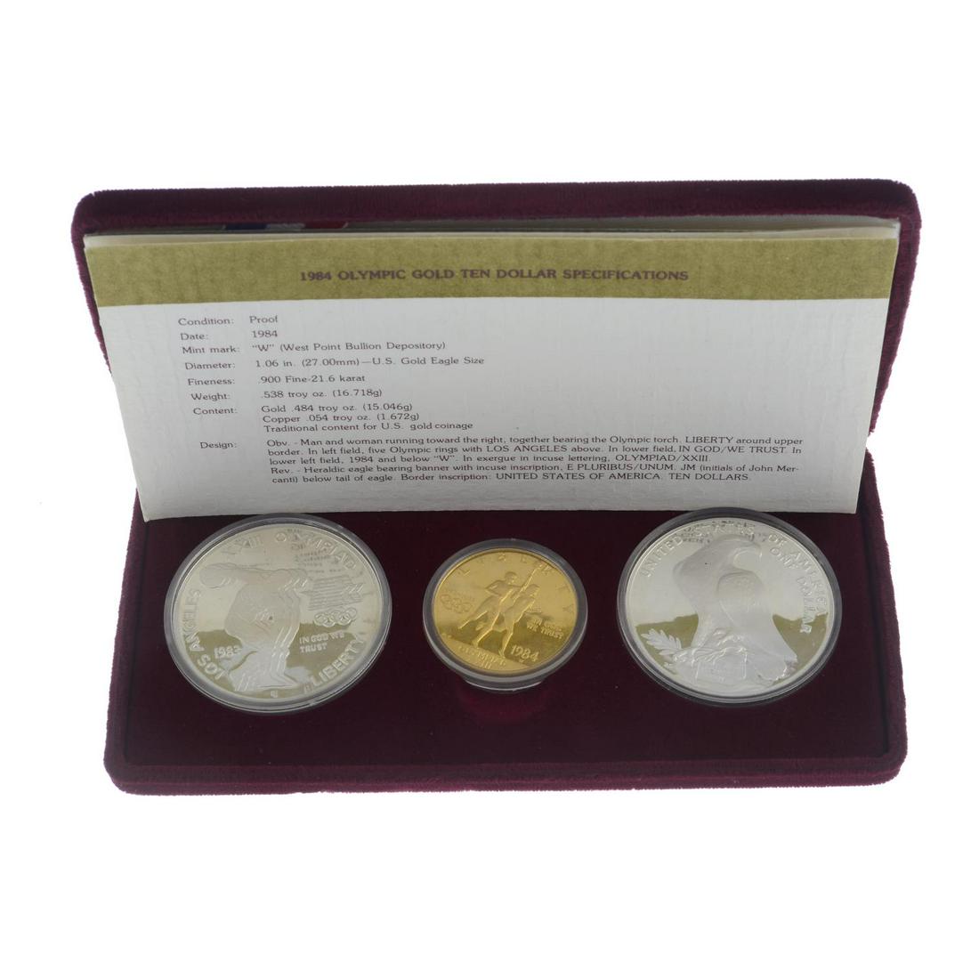 USA, Los Angeles Olympics 1984, commemorative proof: USA, Los Angeles Olympics 1984, commemorative proof coin set comprising gold 10-Dollars, .900 fine, 718g, silver Dollars (2), in fitted US Mint case of issue with certificates. As issued. (3).