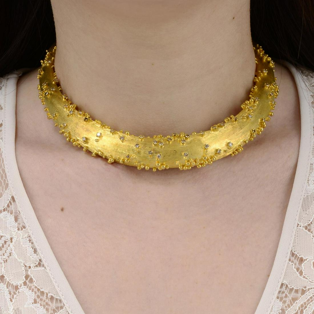 A 1970s 18ct gold diamond collar, by Andrew Grima.: A 1970s 18ct gold diamond collar, by Andrew Grima. Estimated total diamond weight 1.40cts. Hallmarks for London, 1974.Inner diameter 10.5cms. 113.3gms.