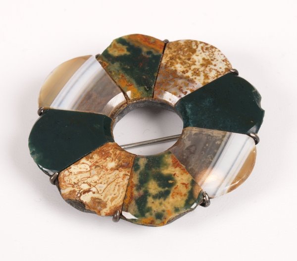 A Scottish pebble brooch with eight shaped panels