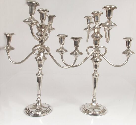 A pair of silver plated five light cand: A pair of silver plated five light candelabra, the twisting four branches with reeded decoration, conforming in design to the detachable nozzles and loaded base, stamped "EP" "KE", 20" (51cm) high.