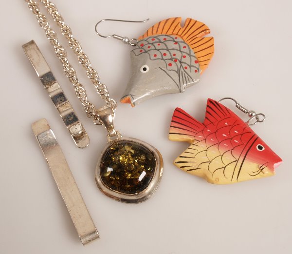 A quantity of silver items, to include various fis: A quantity of silver items, to include various fish design wood earrings, various silver stone set pendants and two silver tie clips.