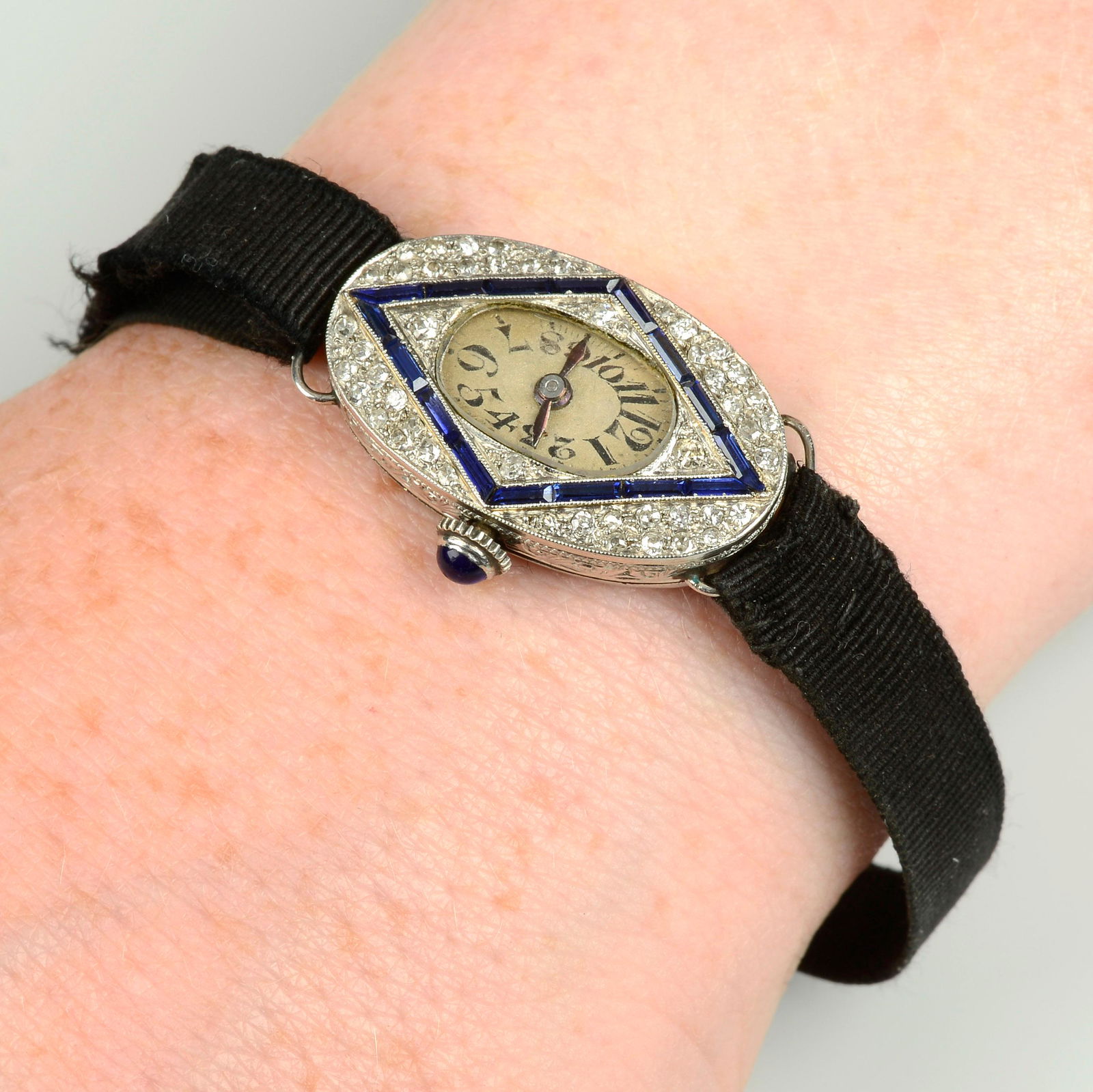 An Art Deco platinum single-cut diamond and calibre-cut sapphire wrist watch, with black fabric (1 of 3)