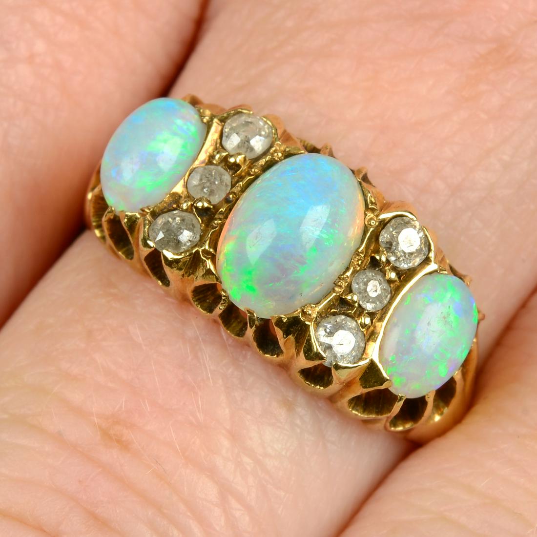 An Edwardian 18ct gold opal three-stone ring, with old-cut diamond spacers. Estimated total diamond (1 of 5)