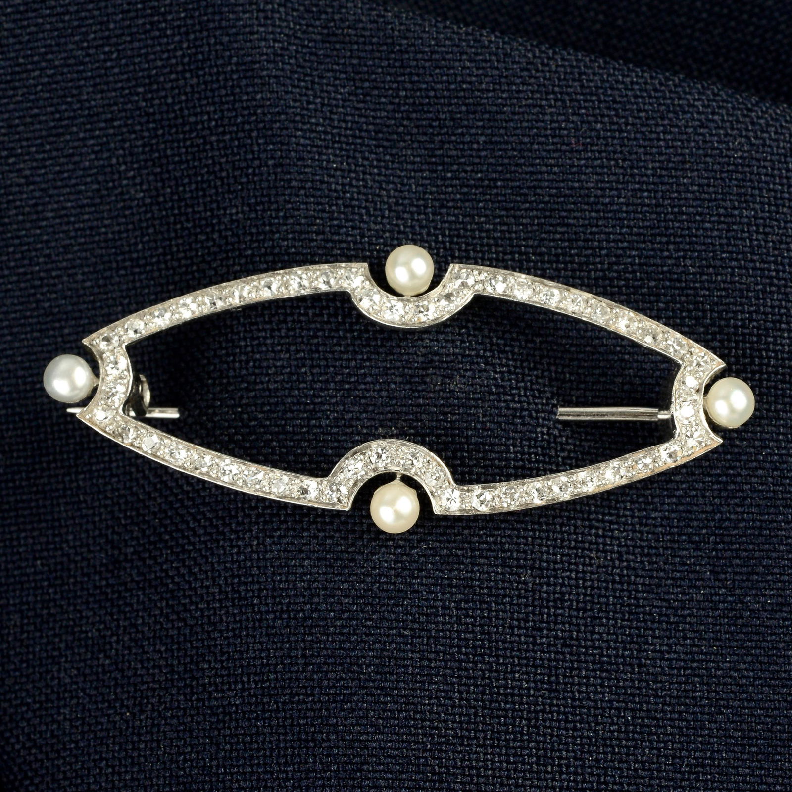 An Art Deco circular-cut diamond and seed pearl geometric brooch.Estimated total diamond weight (1 of 4)