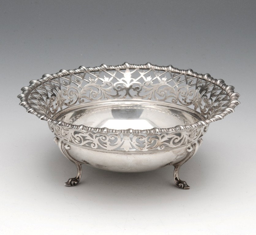 Edwardian silver bonbon dish.: Edwardian silver bonbon dish of circular form with pierced border, gadrooned rim and raised above three scroll feet. Hallmarked James Dixon & Sons Ltd Sheffield 1909, registered number 495815. Diamete