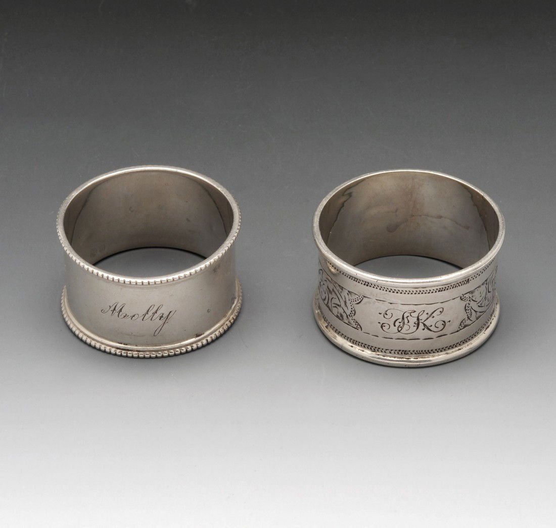 Edwardian silver napkin ring.: Edwardian silver napkin ring of plain form with beaded rim and personal engraving, hallmarked William Hutton & Sons Ltd London 1903. Together with a 1920's example with bright cut scroll engraving, pe